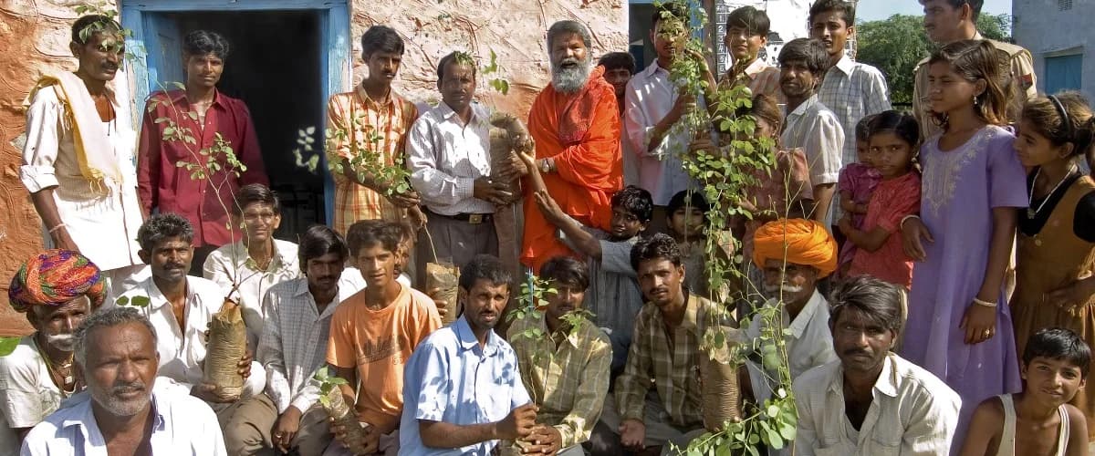 Swami Maheshwarananda among planted trees in Jadan